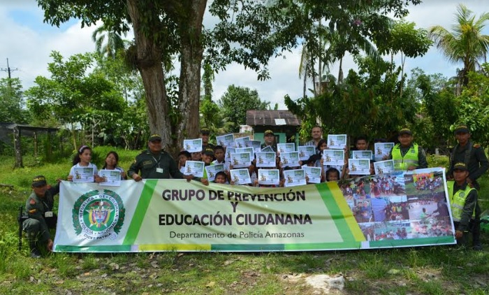 Niños en una foto de clausura de taller con miembros de la policia