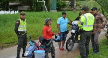 Personas en una calle de Leticia con unos policias